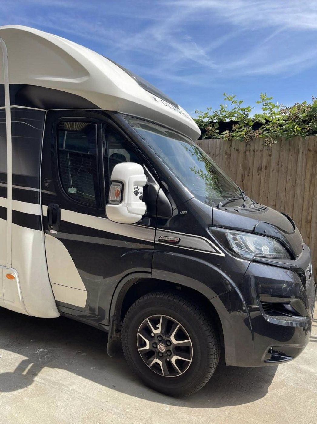 A black and white motorhome seen from the front three-quarter angle