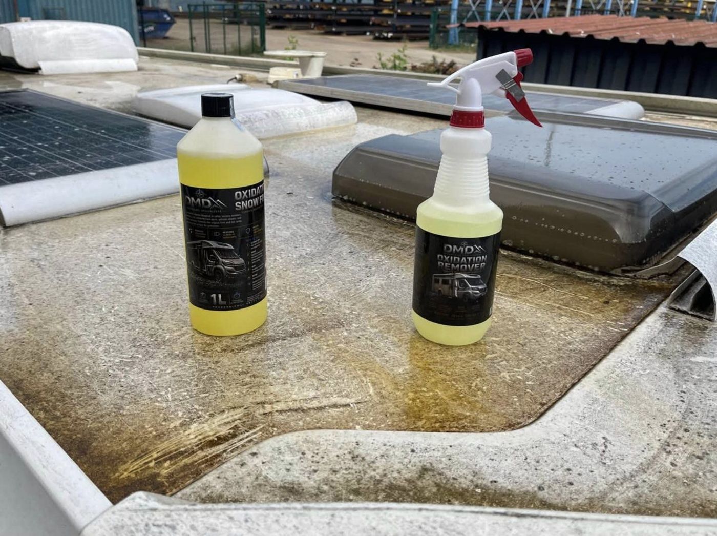 An oxidised motorhome roof with bottles of DMD Oxidation Snow Foam and DMD Oxidation Remover standing on it